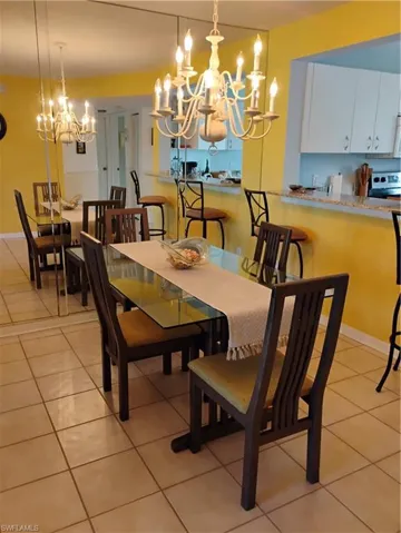 Dining space featuring an inviting chandelier and light tile patterned floors