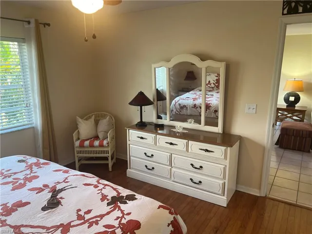 Bedroom with dark hardwood / wood-style flooring