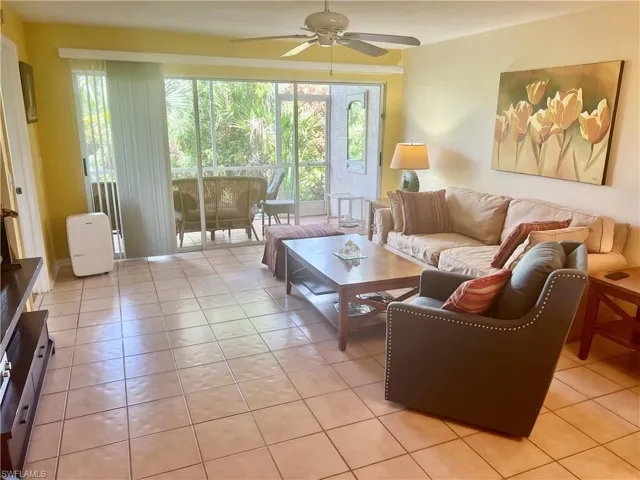 Living room featuring ceiling fan and light tile patterned flooring