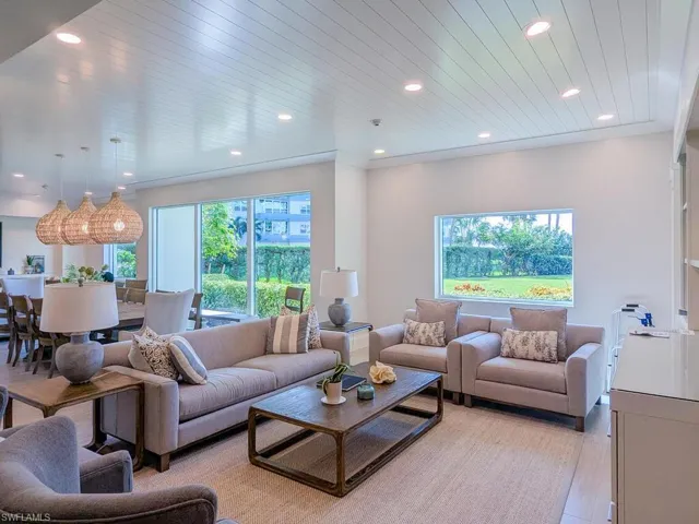 Living room with wooden ceiling and light wood-type flooring