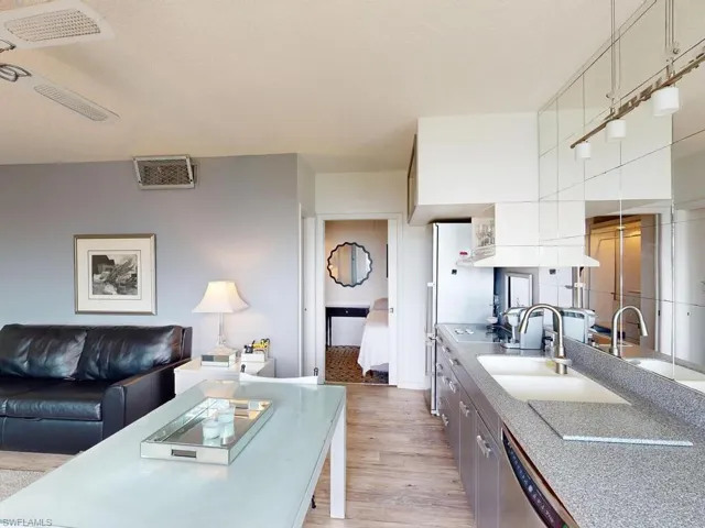 Kitchen featuring dishwasher, sink, and light hardwood / wood-style floors