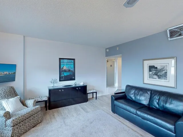 Living room featuring a textured ceiling and hardwood / wood-style flooring