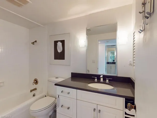 Full bathroom featuring shower / bathing tub combination, vanity, and toilet