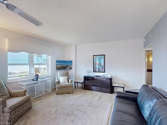 Living room featuring wood-type flooring and a textured ceiling