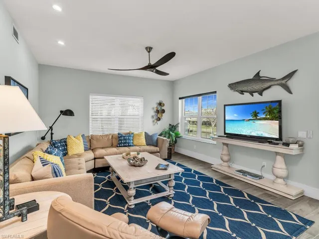 Living room featuring ceiling fan and hardwood / wood-style flooring