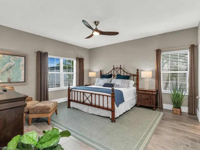 Bedroom with ceiling fan and light hardwood / wood-style floors