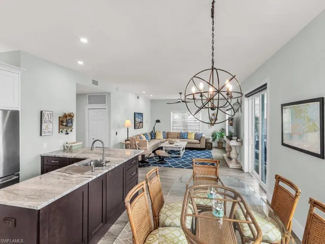 Dining room featuring light hardwood / wood-style flooring, a notable chandelier, and sink