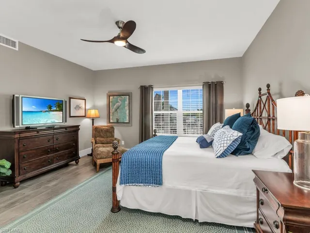 Bedroom with light hardwood / wood-style floors and ceiling fan