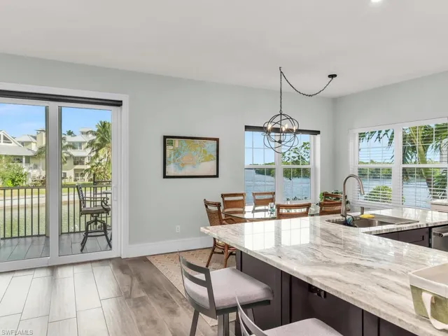 Kitchen featuring pendant lighting, a water view, a wealth of natural light, and sink