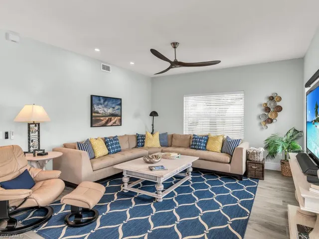 Living room featuring ceiling fan and wood-type flooring