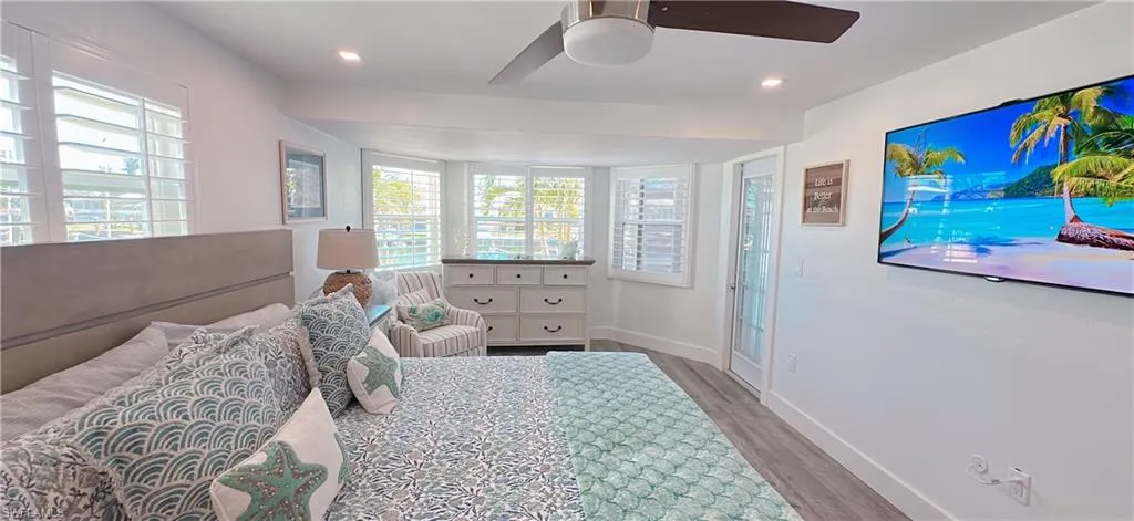 Bedroom featuring recessed lighting, ceiling fan, baseboards, and wood finished floors