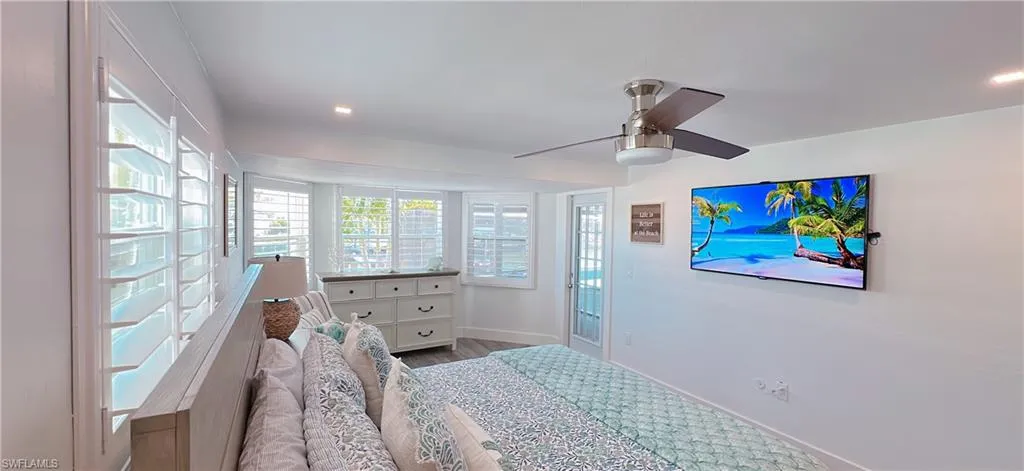Bedroom featuring wood finished floors, baseboards, and ceiling fan