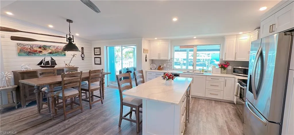 Kitchen with white cabinets, appliances with stainless steel finishes, and a kitchen island