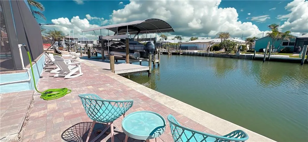 Dock area with a water view and boat lift