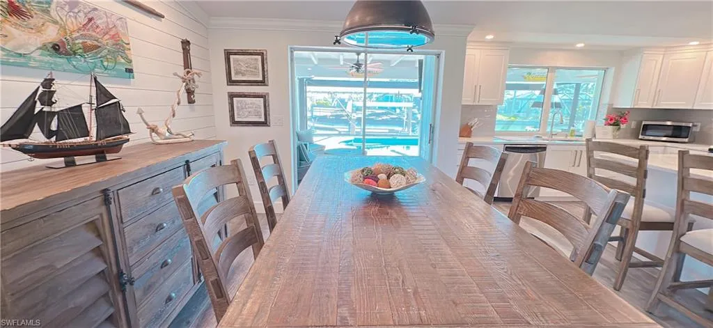 Dining space with recessed lighting and ornamental molding