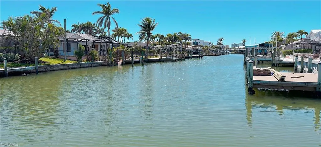 Dock area with a residential view and a water view