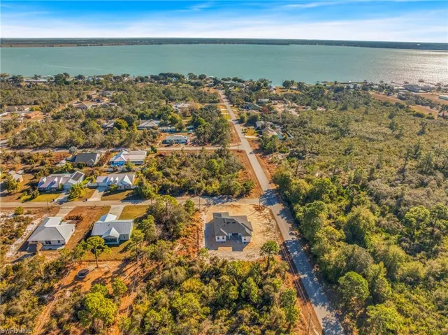 View of property location with a large body of water and nearby suburban area