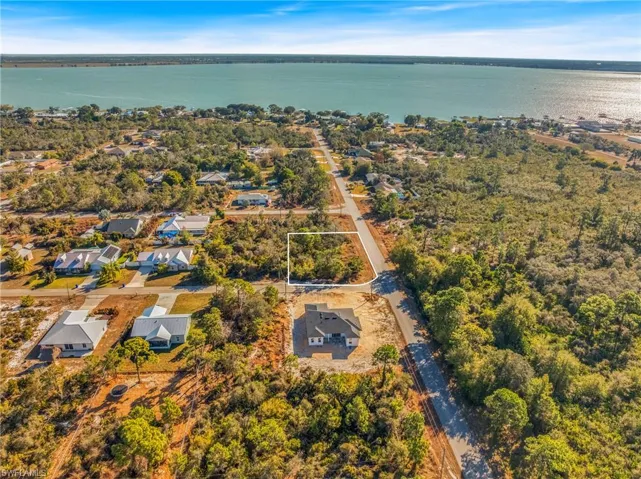 View of property location featuring a large body of water and nearby suburban area