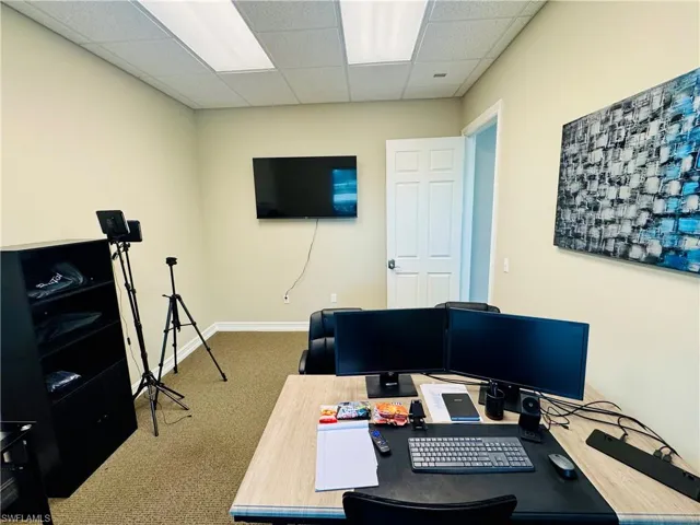 Office space with a paneled ceiling