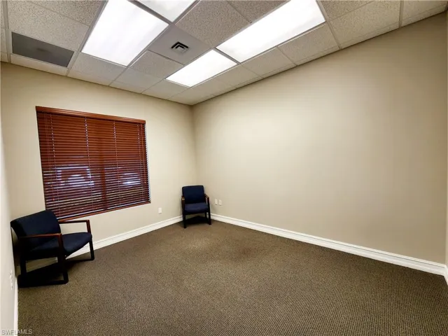 Unfurnished room with a drop ceiling