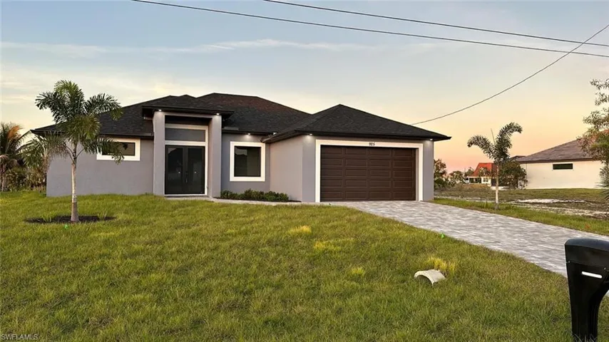 Prairie-style home with a yard and a garage