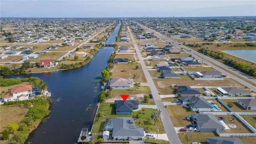 Birds eye view of property with a water view