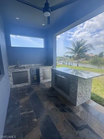 View of patio / terrace with wine cooler, an outdoor kitchen, and a sink