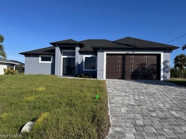 Prairie-style house with a front yard and a garage