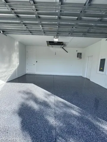 Garage with electric panel and tankless waterheater