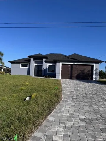 Prairie-style house with a front yard and a garage