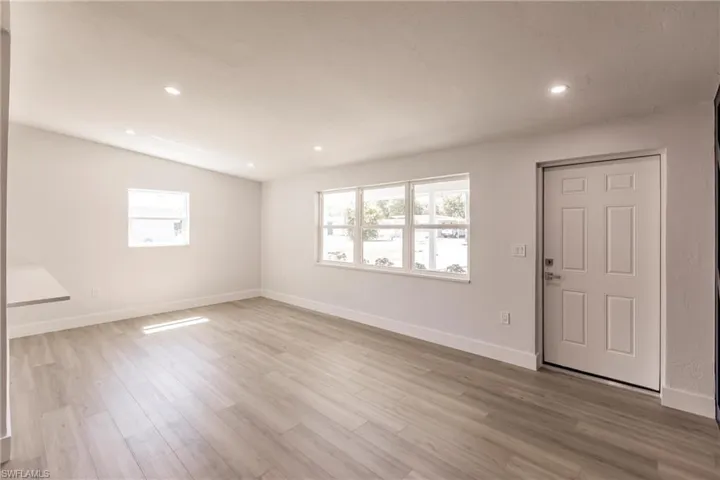 Empty room with light hardwood / wood-style flooring