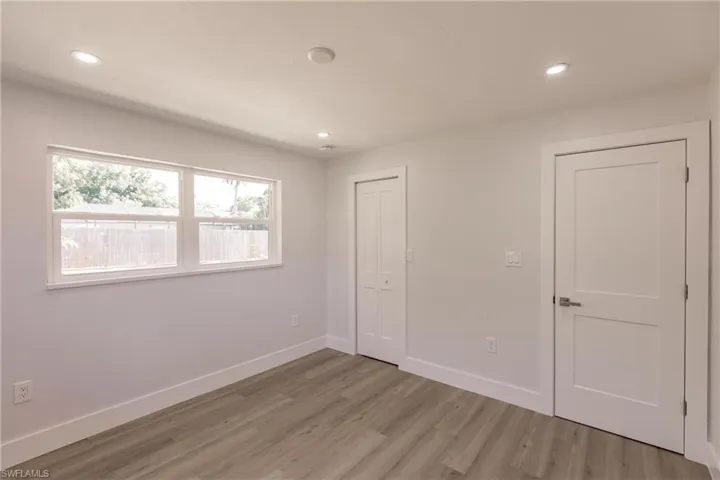 Unfurnished bedroom featuring hardwood / wood-style flooring