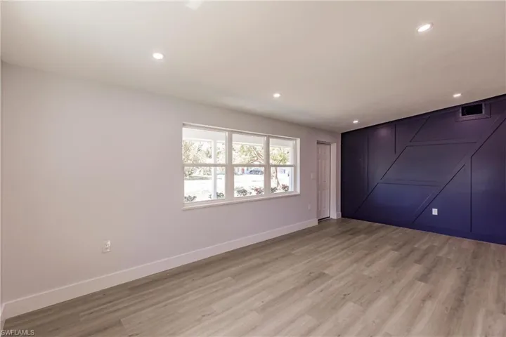 Empty room with hardwood / wood-style floors