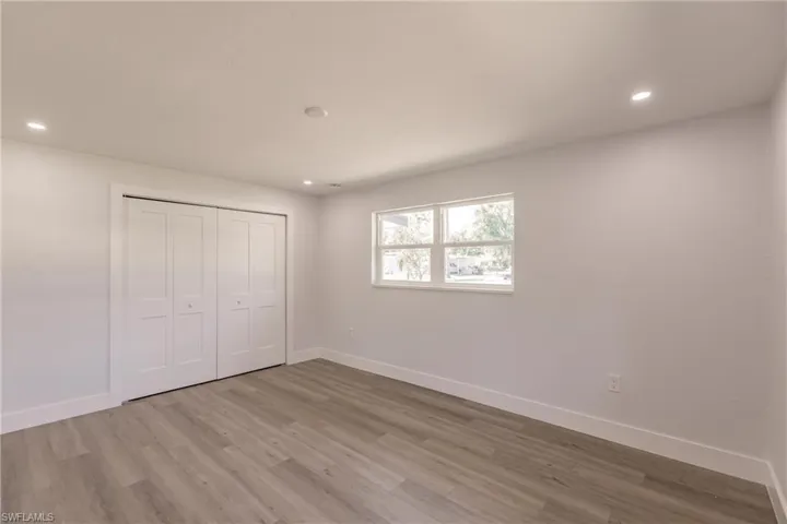 Unfurnished bedroom with a closet and wood-type flooring