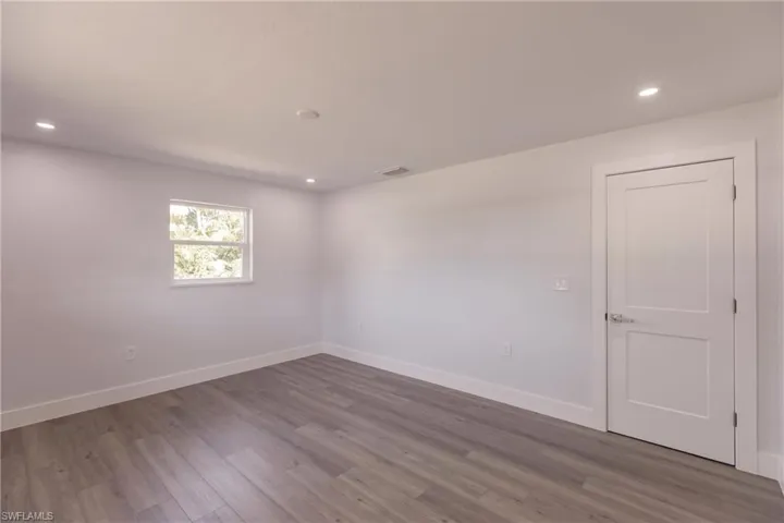Unfurnished room featuring dark hardwood / wood-style floors