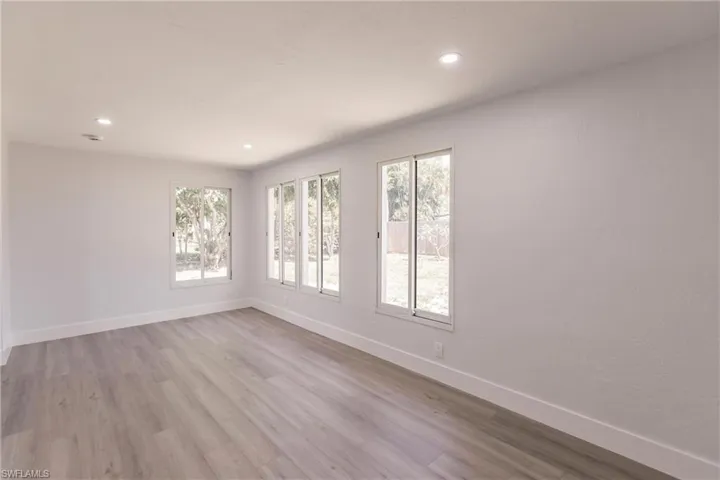 Empty room with hardwood / wood-style floors