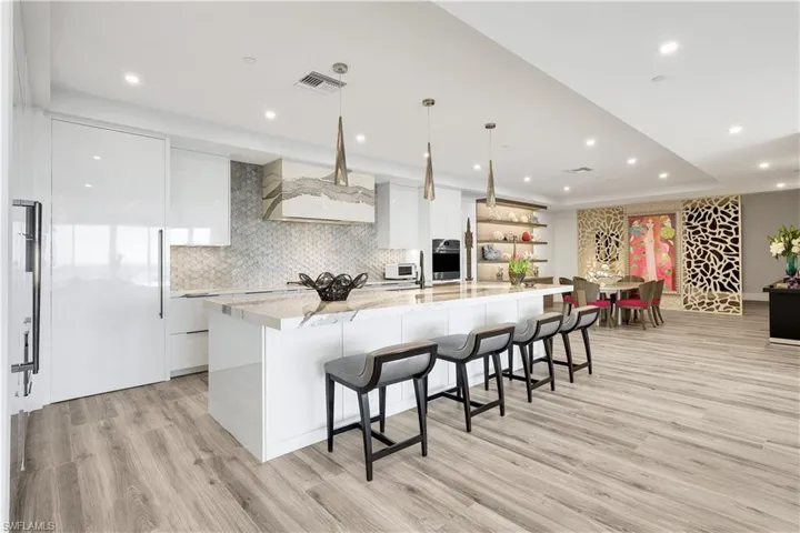 A grand kitchen island elegantly merges functionality and sophistication, offering abundant storage.
