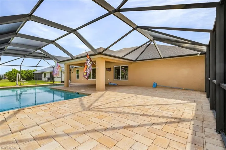 Pool with a lanai and a patio