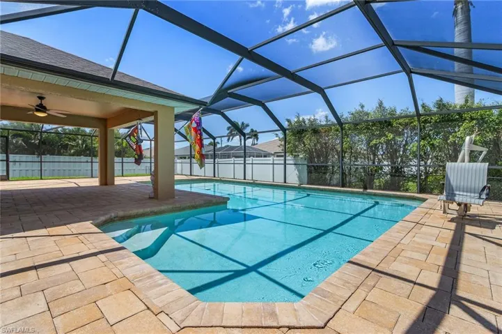 View of swimming pool featuring ceiling fan, a fenced backyard, a patio area, a lanai, and a fenced in pool