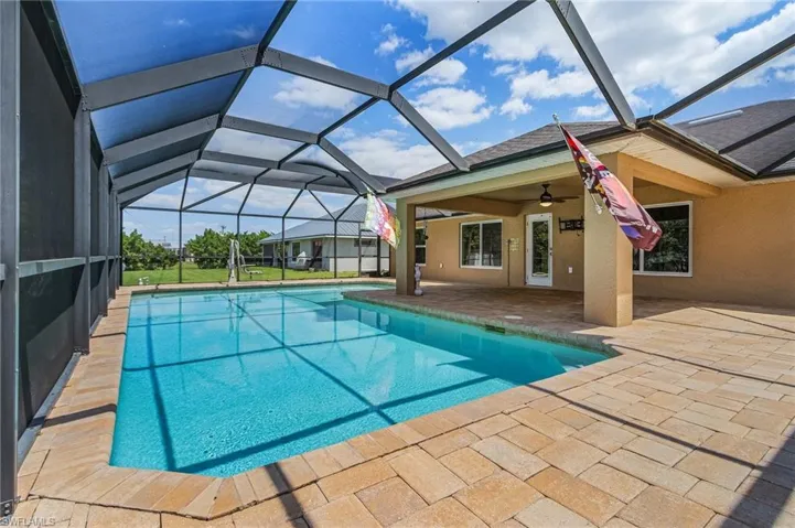 Outdoor pool featuring a patio, a lanai, and a ceiling fan
