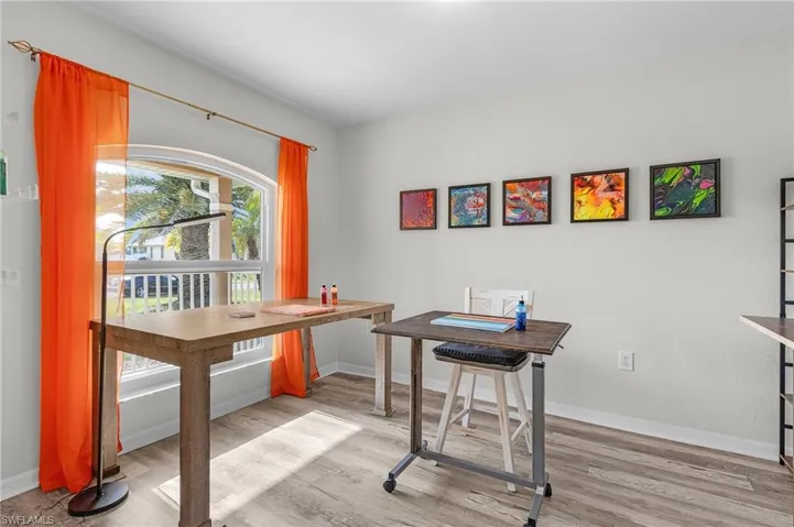 Office space featuring light wood-type flooring and baseboards