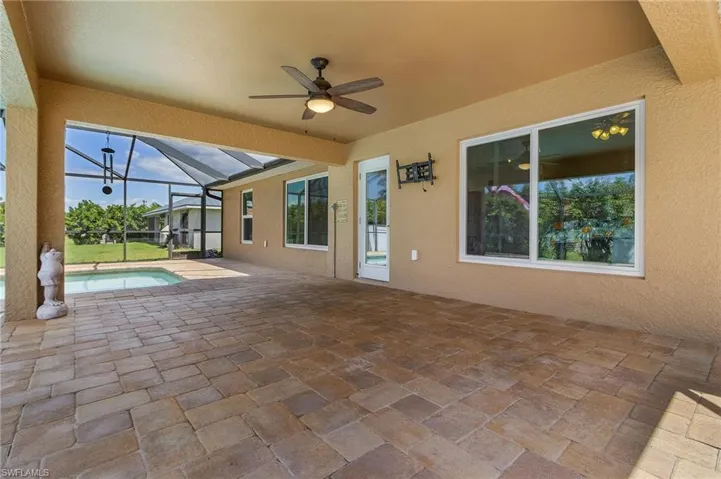 View of patio / terrace featuring an outdoor pool, a lanai, and ceiling fan