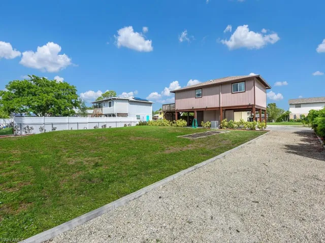 Back of house featuring gravel driveway