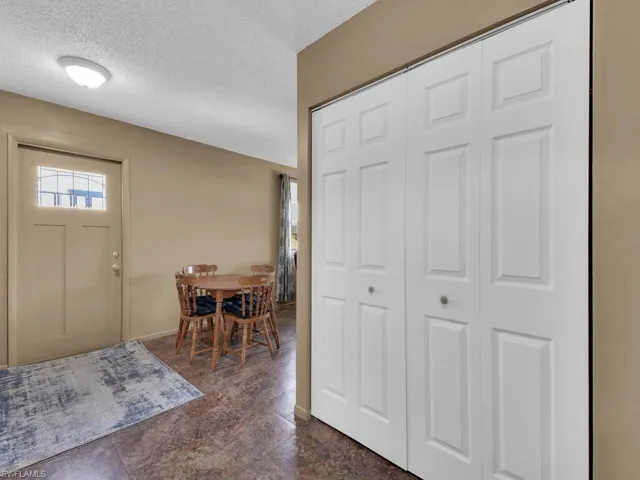 Entrance foyer featuring a textured ceiling and baseboards