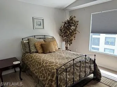 Bedroom with vaulted ceiling and wood finished floors