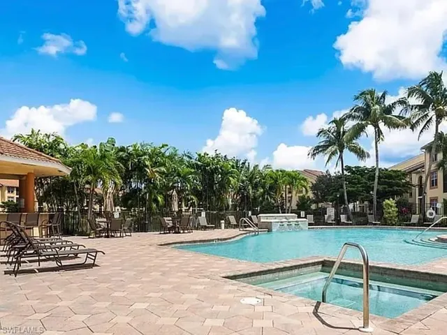 Community pool with a hot tub and a patio