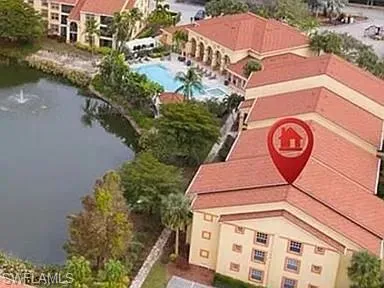 Bird's eye view of a pool area and a large body of water