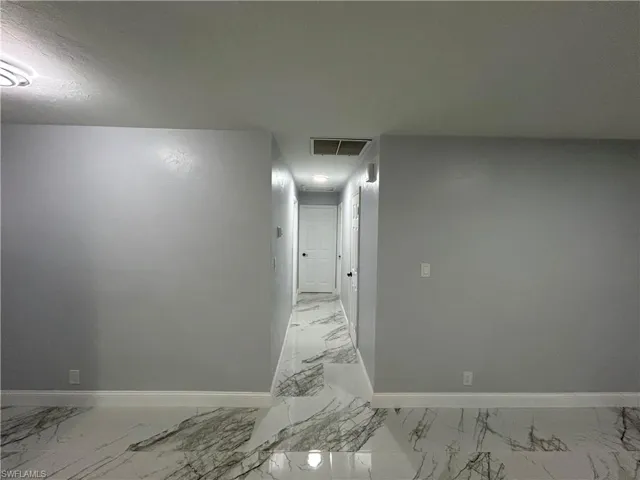 Hall with light tile floors