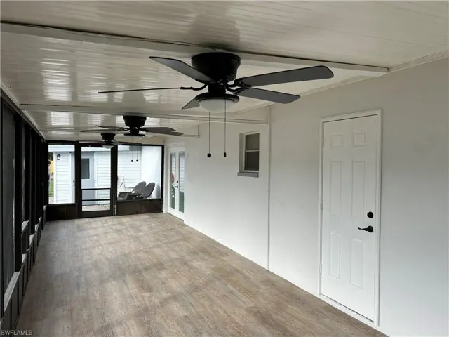 Unfurnished sunroom with ceiling fan