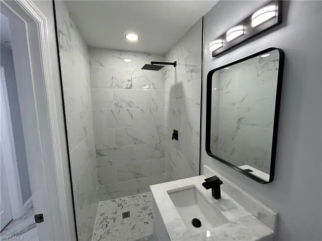 Bathroom with a tile shower and sink